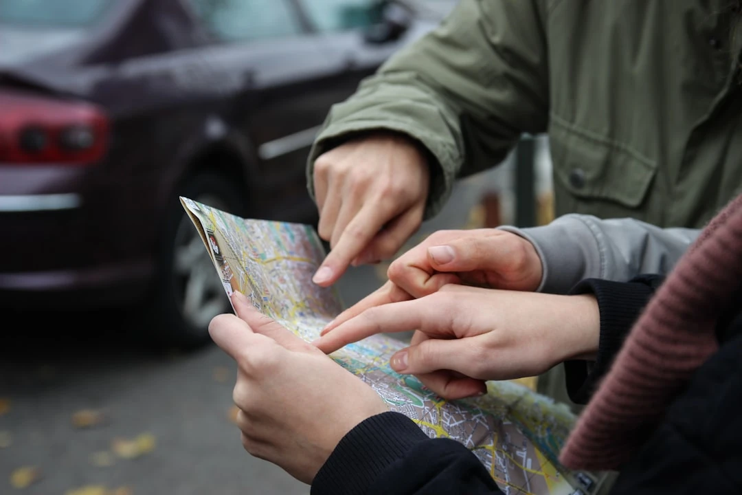 People pointing at a paper map.
